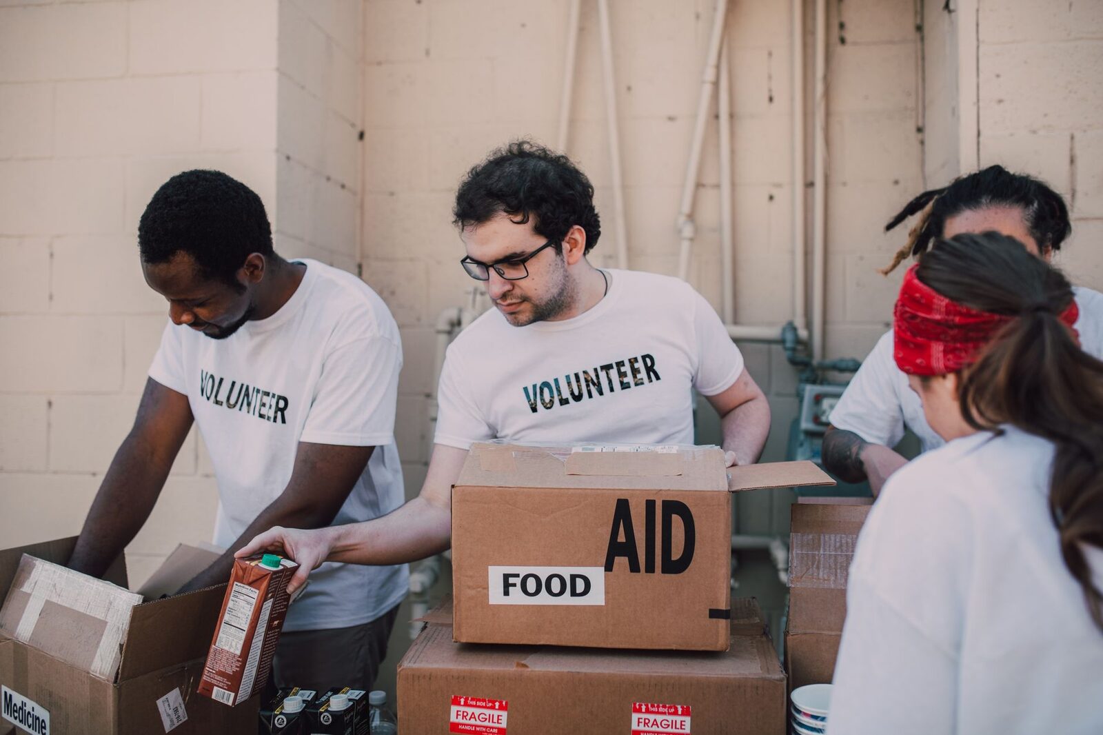 Volunteers packing food and aid boxes together